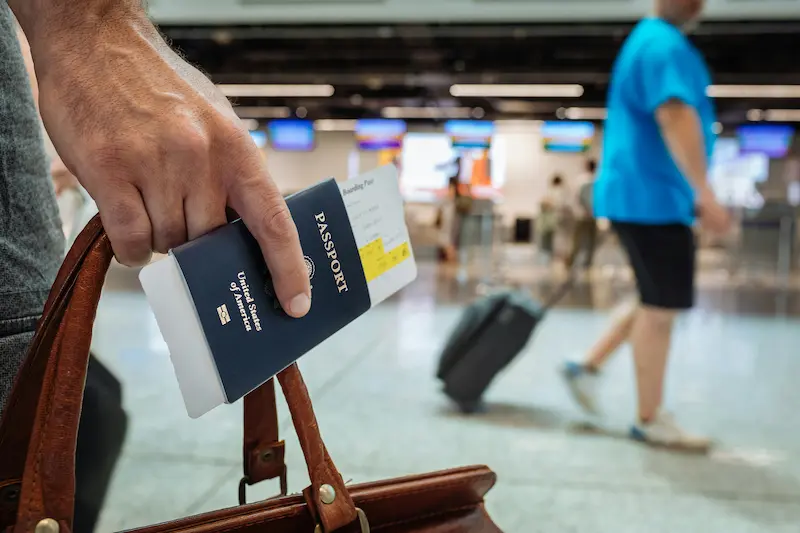 Traveler checking in at Priority Pass lounge reception at Las Vegas Airport showing boarding pass and membership card for entry
