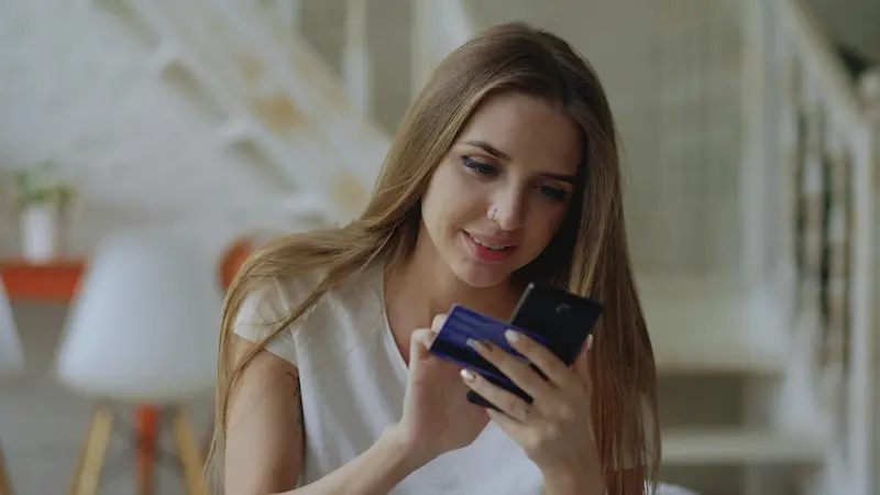 Person reviewing travel credit card application on a smartphone before applying