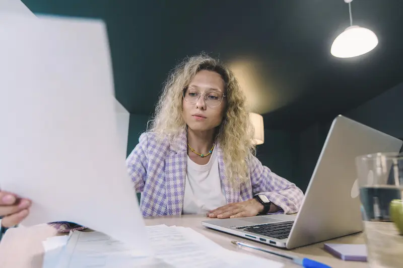 Person reviewing personal loan options to decide if Pennie Loans is right for them in 2026