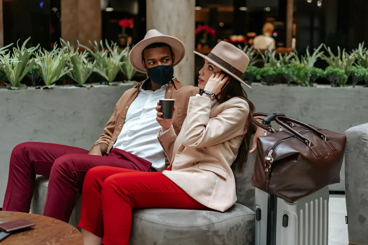 Travelers at the airport using credit card points and miles to save on holiday travel in 2026