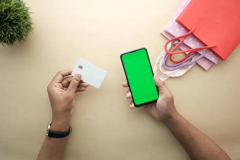 Credit cards spread next to a smartphone showing rewards dashboard for maximizing cannabis-related spending in 2026