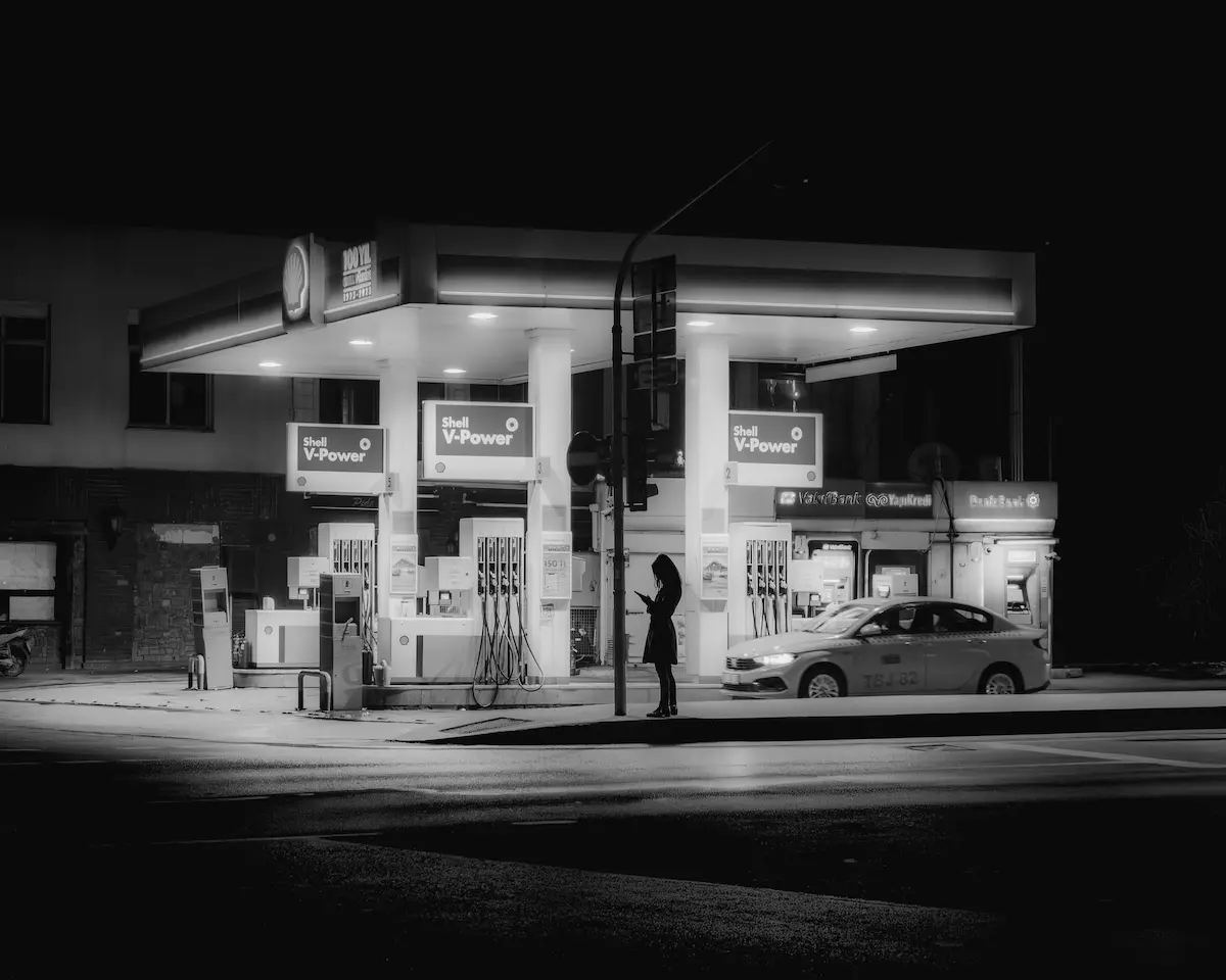 Person paying with a credit card at a gas station pump — Shell Performance Elite World Mastercard review 2026