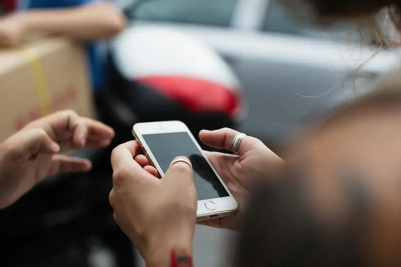 Person using a mobile app at a gas station pump to stack fuel rewards with a credit card in 2026
