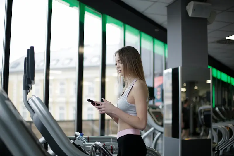 Person reviewing financing options next to fitness equipment representing DICK'S Mastercard special financing tiers 2026