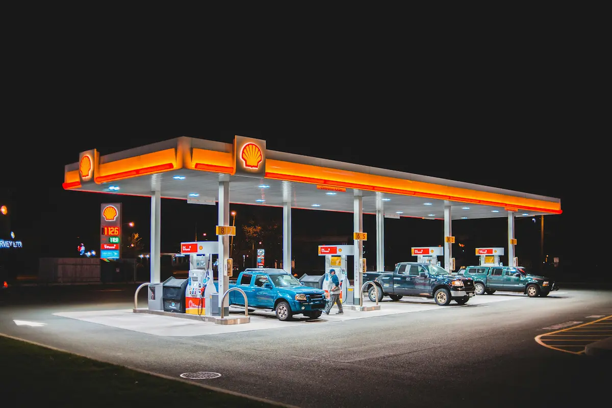 Person paying with a credit card at a gas station pump — Shell Performance Elite World Mastercard review 2026