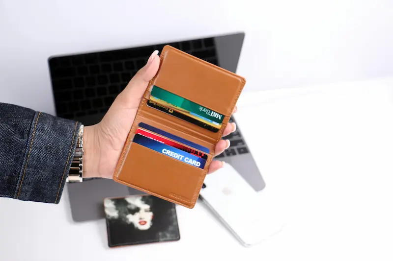 Open wallet showing two credit cards — representing the recommended two-card strategy of pairing the AAA Daily Advantage Visa Signature with a flat-rate card for maximum everyday rewards in 2026