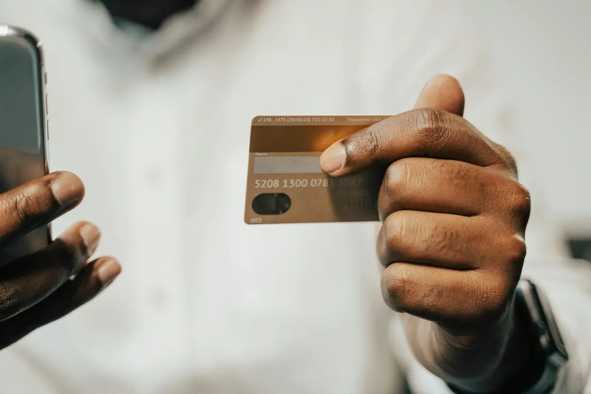 Person using a mobile banking app to manage the Current Build Visa Credit Card for credit building in 2026