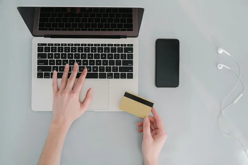 Multiple credit cards laid out alongside a smartphone showing a rewards savings dashboard for break-even analysis in 2026
