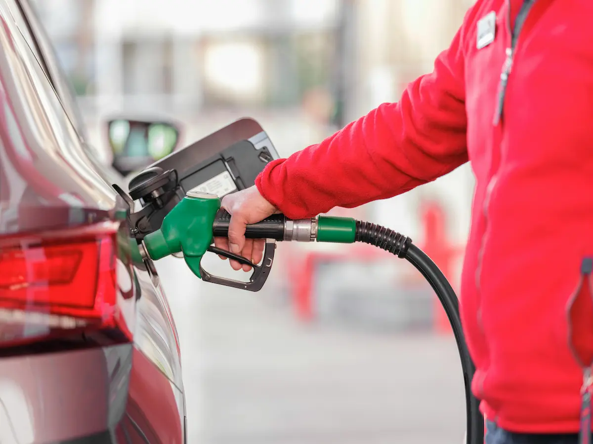 Driver filling up at a gas station using a credit card, representing how the AAA Travel Advantage Visa Card earns elevated cash back on gas purchases in 2026.
