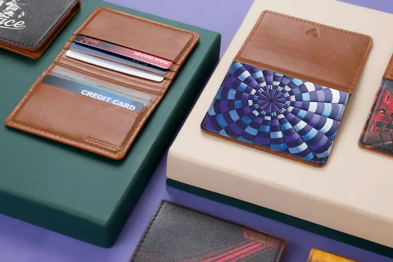 Person reviewing multiple credit cards on a desk, representing how the AAA Travel Advantage Visa Card compares to no-fee travel and flat-rate cash back alternatives in 2026.