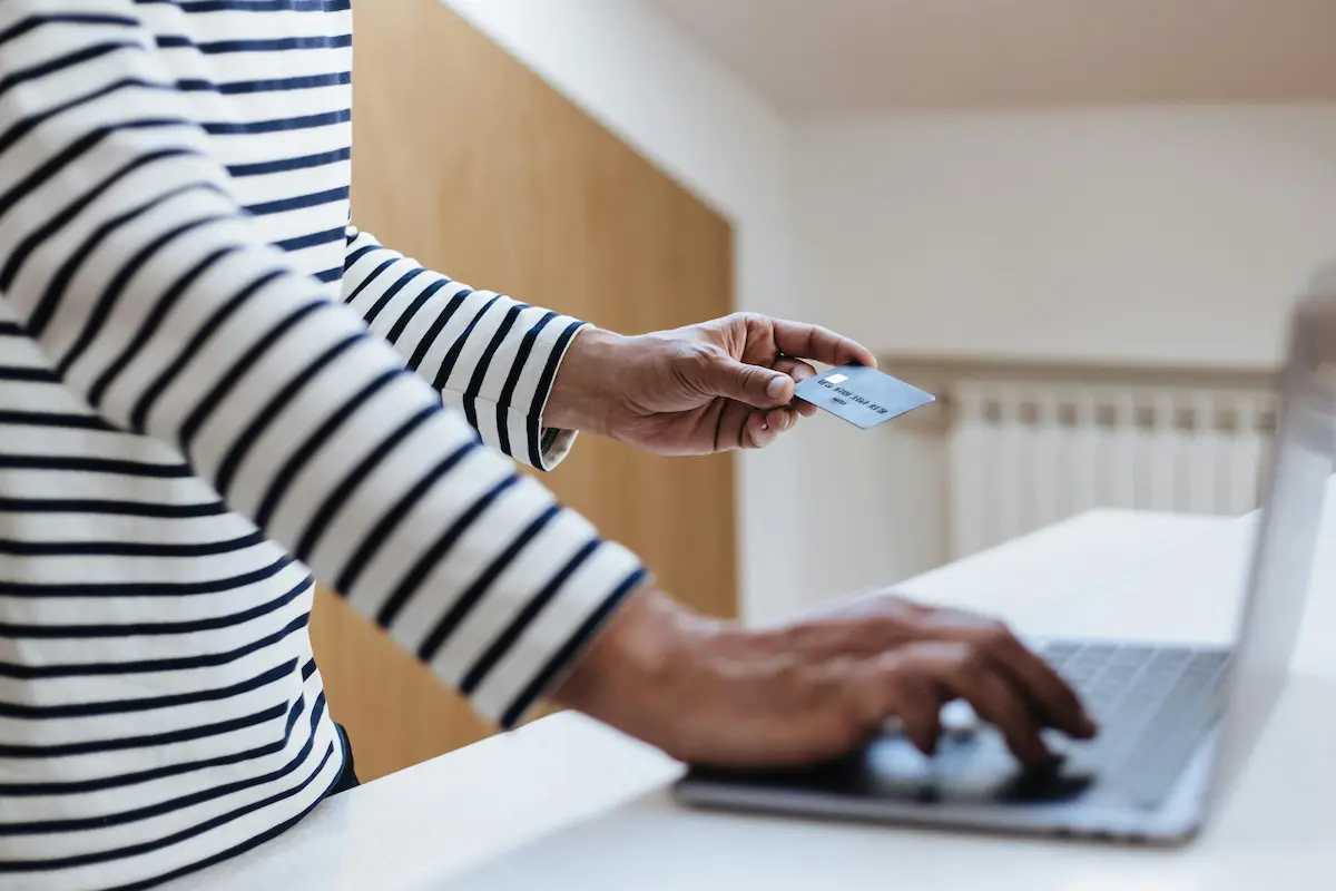 Person paying for an online purchase using a credit card with Klarna buy now pay later at checkout in 2026