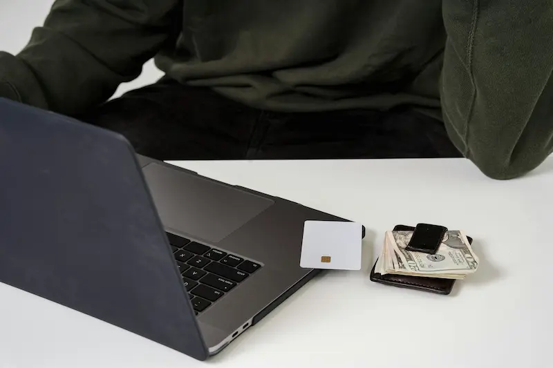 Person weighing decision to use a credit card for Klarna payments, considering rewards versus interest risk in 2026