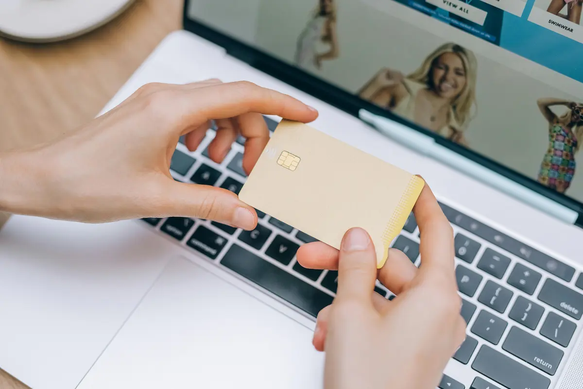 Person holding a credit card representing a fresh start for rebuilding credit with the First Access Visa Card in 2026