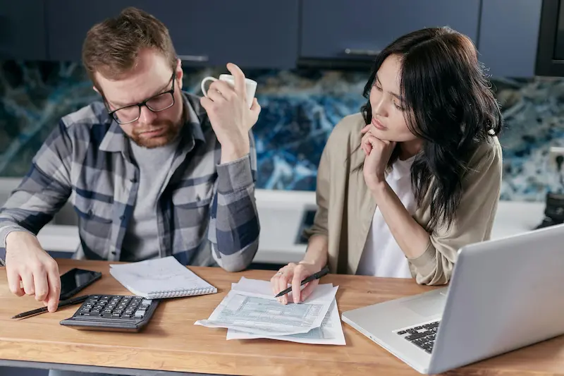 Person reviewing credit card fee structure and cost breakdown, representing the layered fees of the First Access Visa Card in 2026
