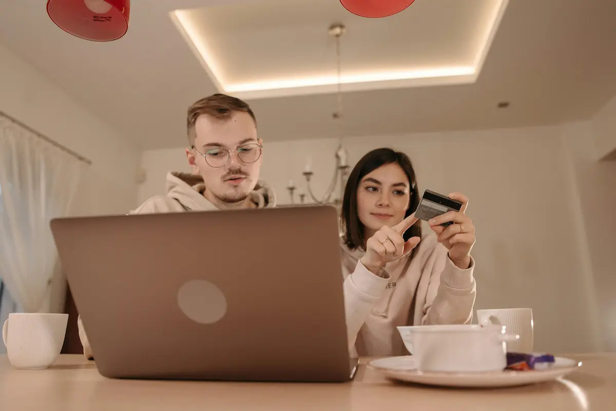Person reviewing Capital One account online to cancel or downgrade their card and request an annual fee refund