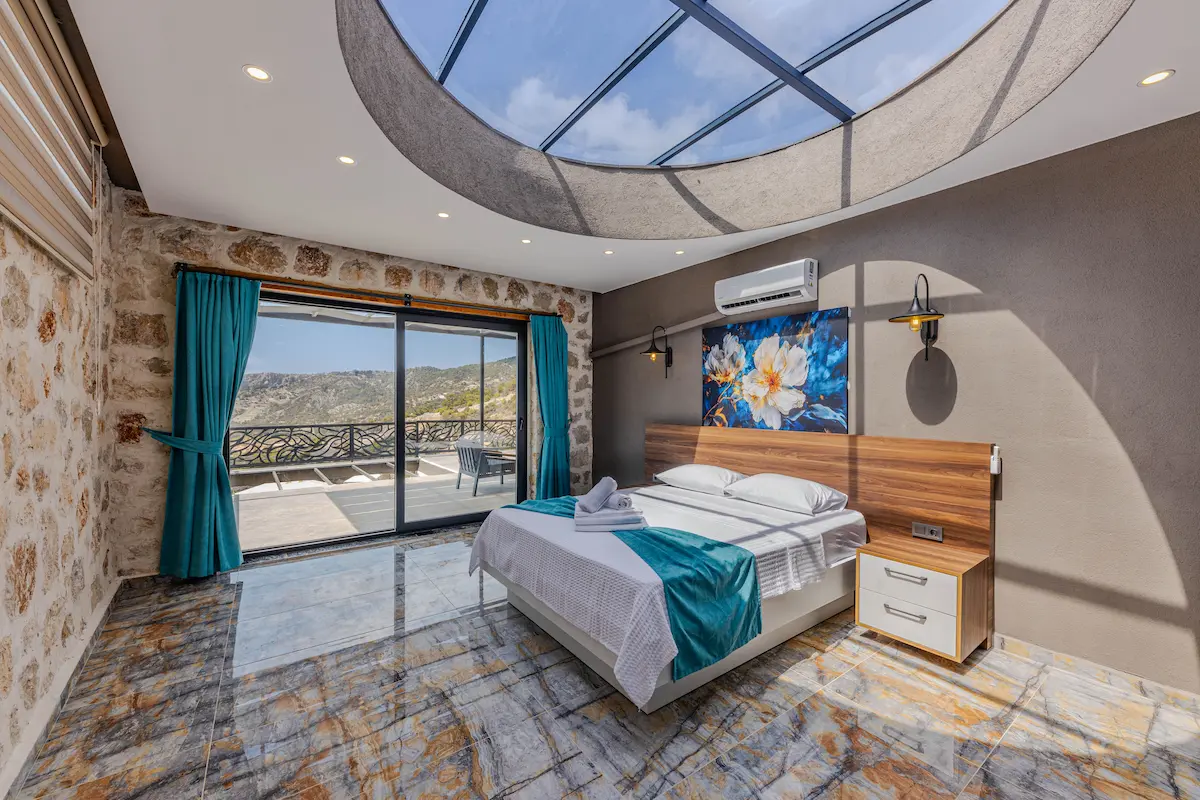 Boutique hotel room with skylight and mountain-view balcony, the kind of stay bookable through The Edit collection