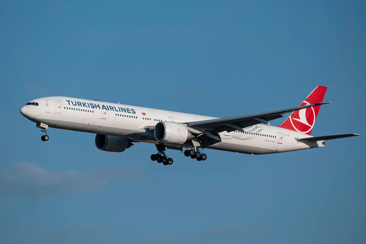 Turkish Airlines Boeing 777 aircraft flying against a blue sky