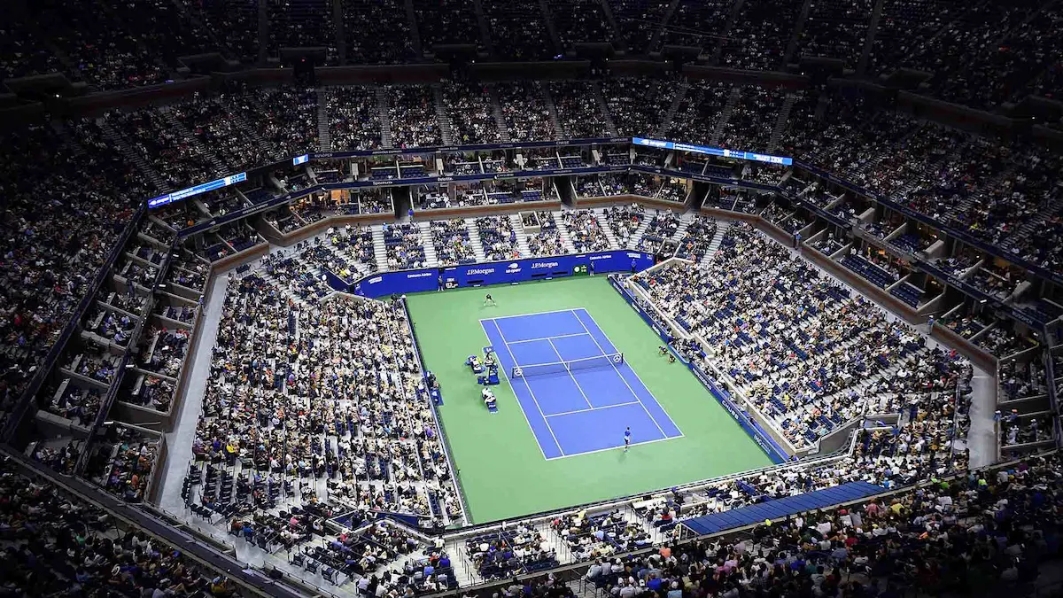 US Open tennis tournament at Arthur Ashe Stadium, full crowd view of the court during a match.