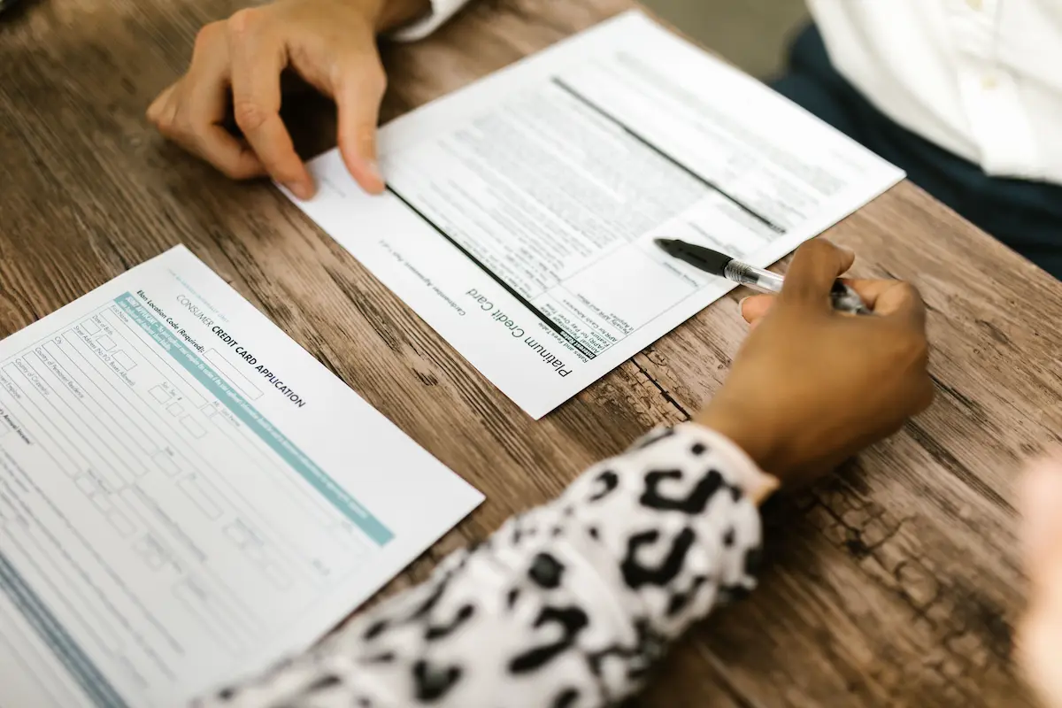 Person filling out a credit card application form
