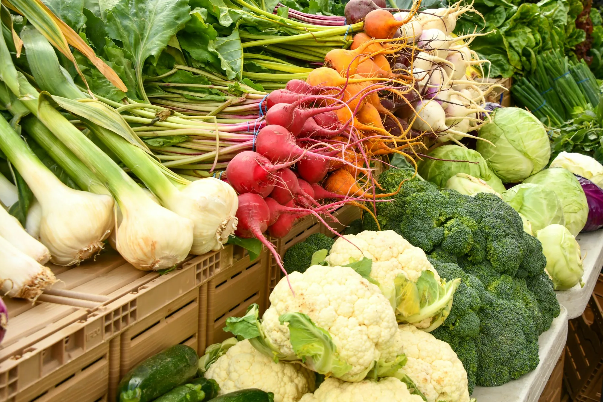 Fresh produce stacked at an open-air market stall