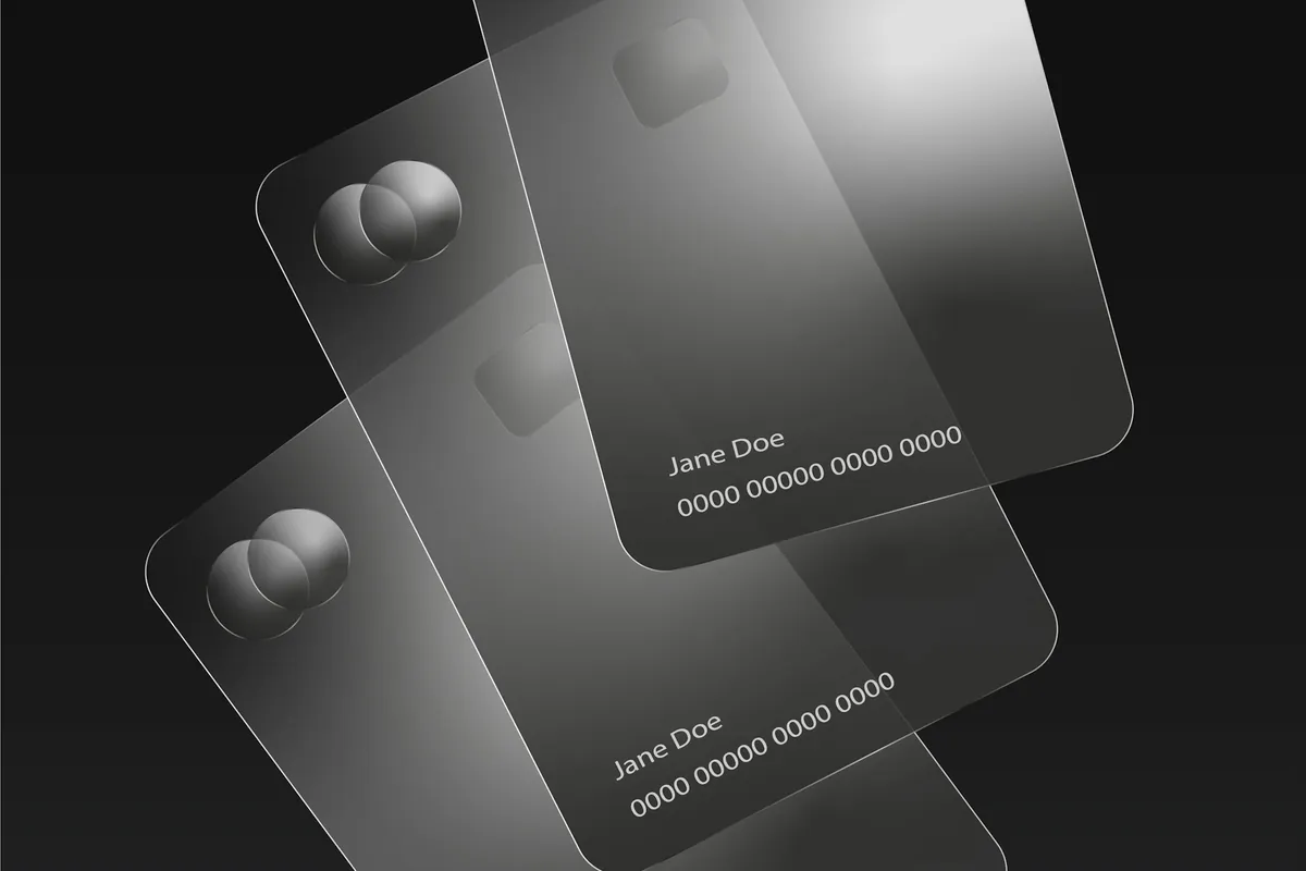 Three credit cards fanned out on a plain surface
