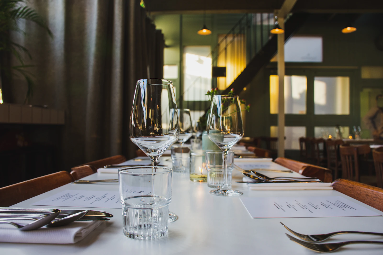 A set restaurant table with wine glasses and cutlery