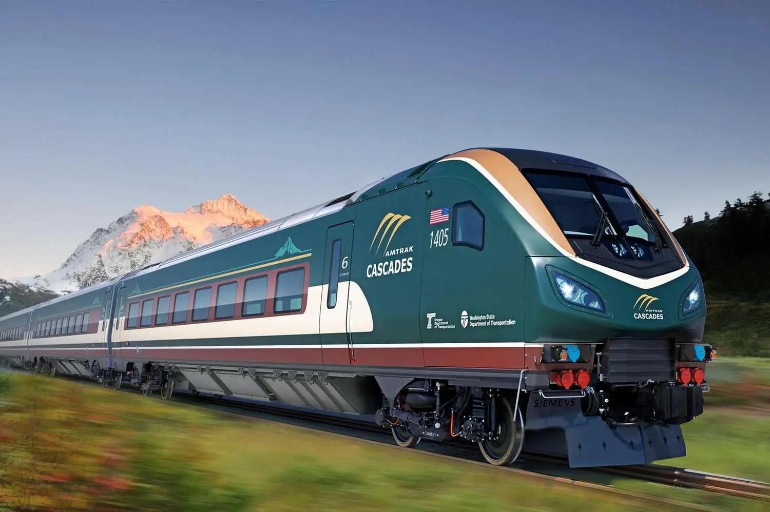 Green and cream Amtrak Cascades train traveling past a snow-capped mountain in the Pacific Northwest.