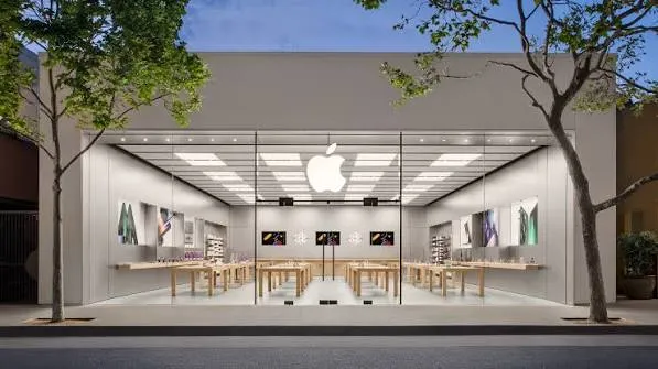 Exterior of an Apple Store with glass storefront and illuminated Apple logo