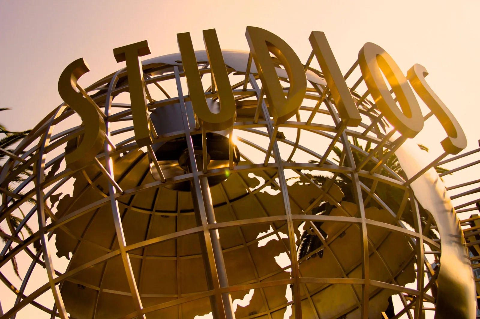 Close-up of the Universal Studios globe sculpture at sunset