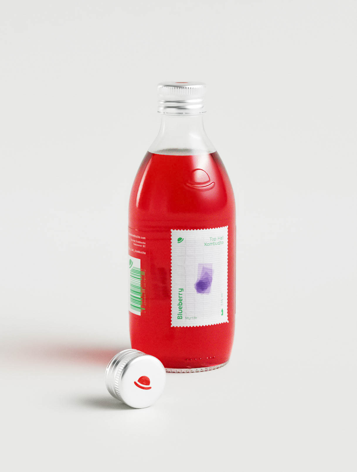 A bottle of kombucha is placed on a white surface with its silver cap resting beside it, revealing an embossed top hat mark directly in the glass. The red beverage contrasts with the clean, minimal label featuring a postage stamp–inspired frame, fine grid lines, and a soft geometric visual in purple. Typography is arranged vertically and delicately, identifying the blueberry flavor. The design uses restraint and precision typical of a packaging design agency, balancing clarity with subtle branding cues for a contemporary premium beverage.