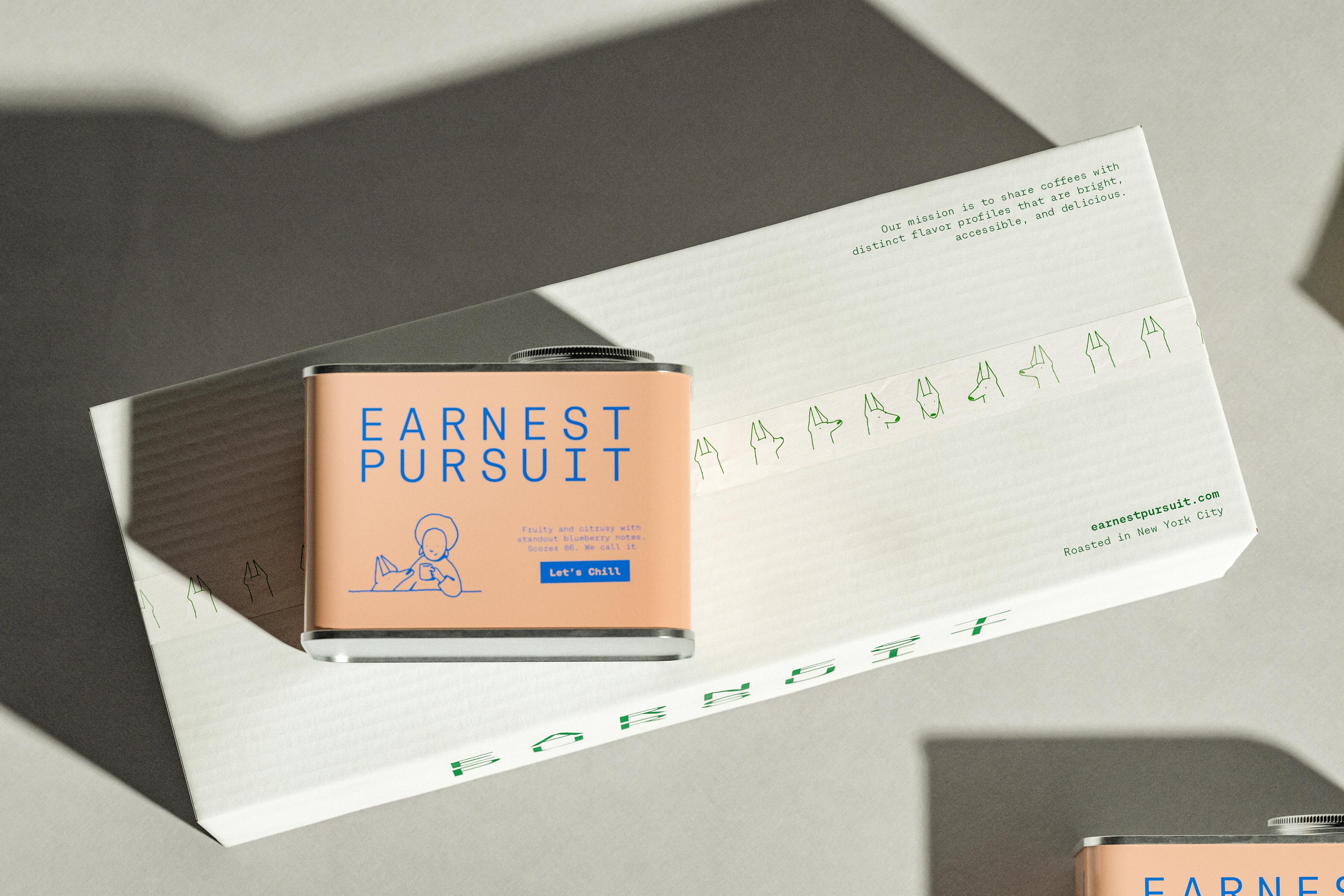 Hard sun from above throws long grey shadows across a white corrugated Earnest Pursuit shipping box, its seam taped with a band of green dog heads drawn in single strokes and turned every which way. A peach tin rests on top, and the box carries "Our mission is to share coffees with distinct flavor profiles that are bright, accessible, and delicious." along with "earnestpursuit.com" and "Roasted in New York City", while the wordmark runs off its lower edge. The branding studio pushed the identity all the way down to the tape, a level of commitment most brands reserve for the logo.
