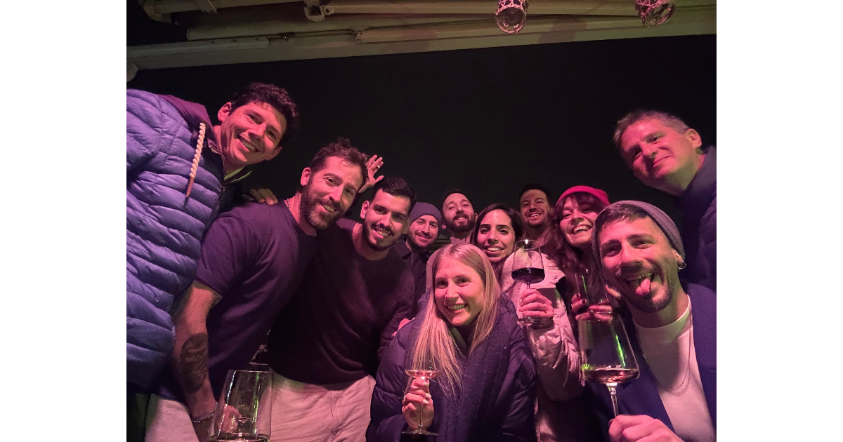 Anchor team members pause for a group photo outside a mountain lodge.