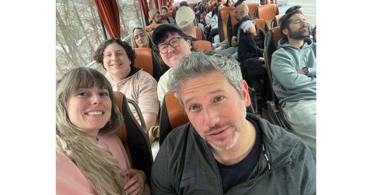 Image of team members together on a bus, taken from the front looking down the aisle.