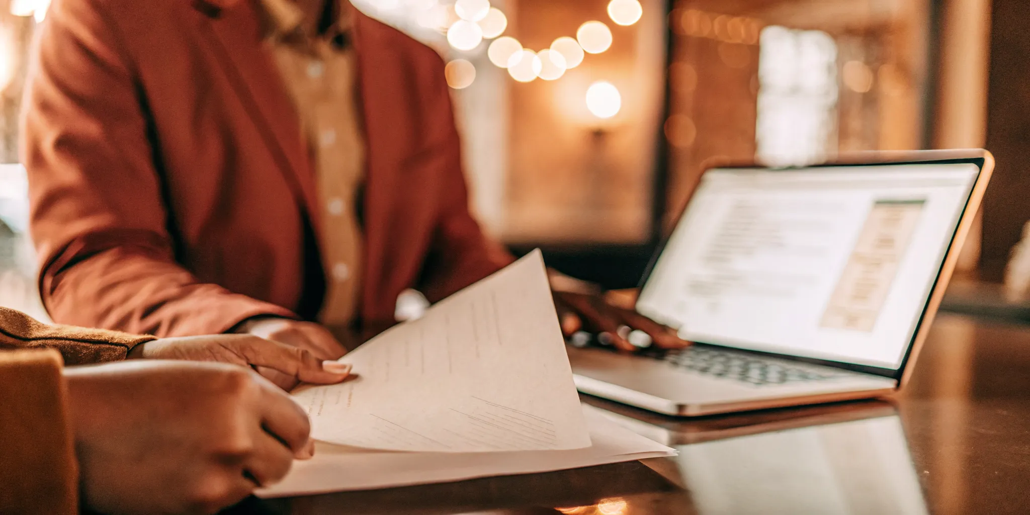 Tax engagement letter on desk with billing workflow dashboard on laptop