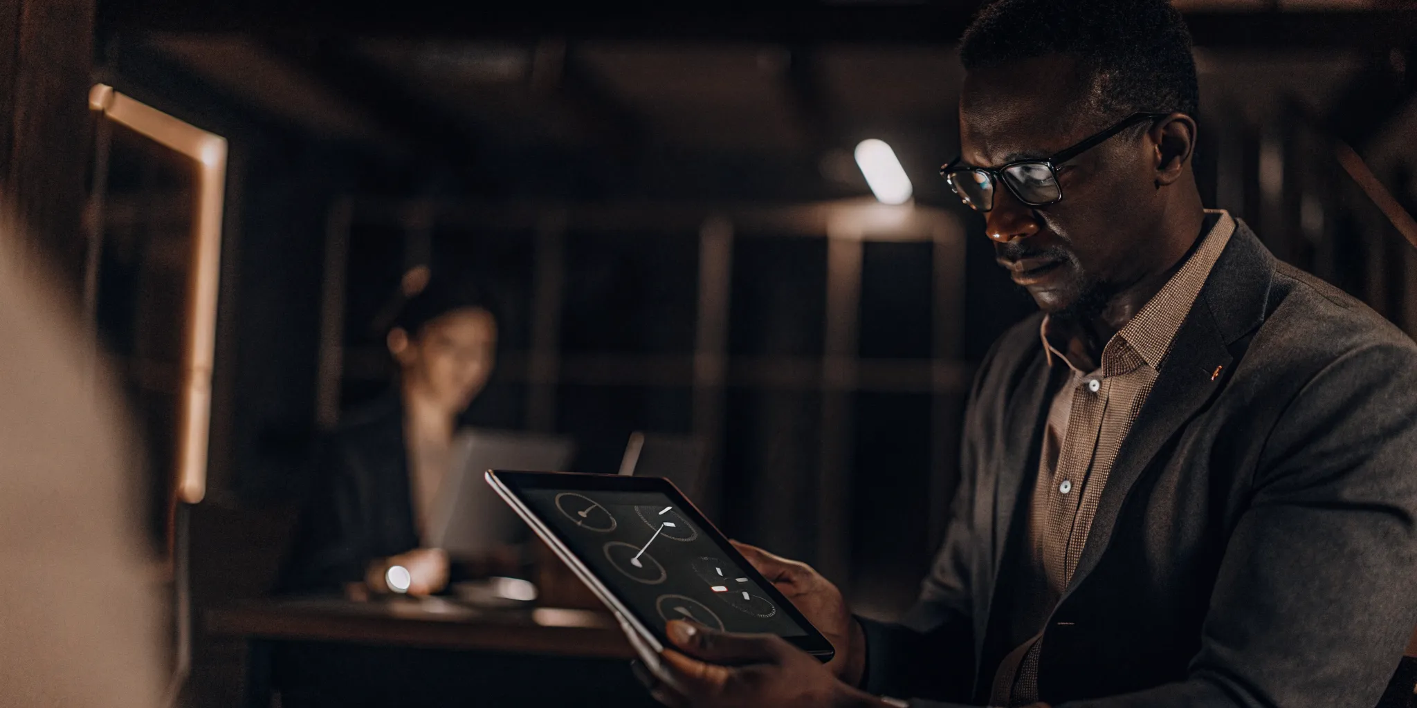 Accountant reviewing automated payment reconciliation on tablet with fraud detection alerts