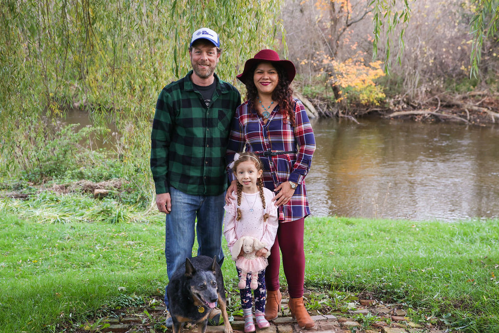 Yessicka and her family. Included in the image are her husband, daughter, and dog.