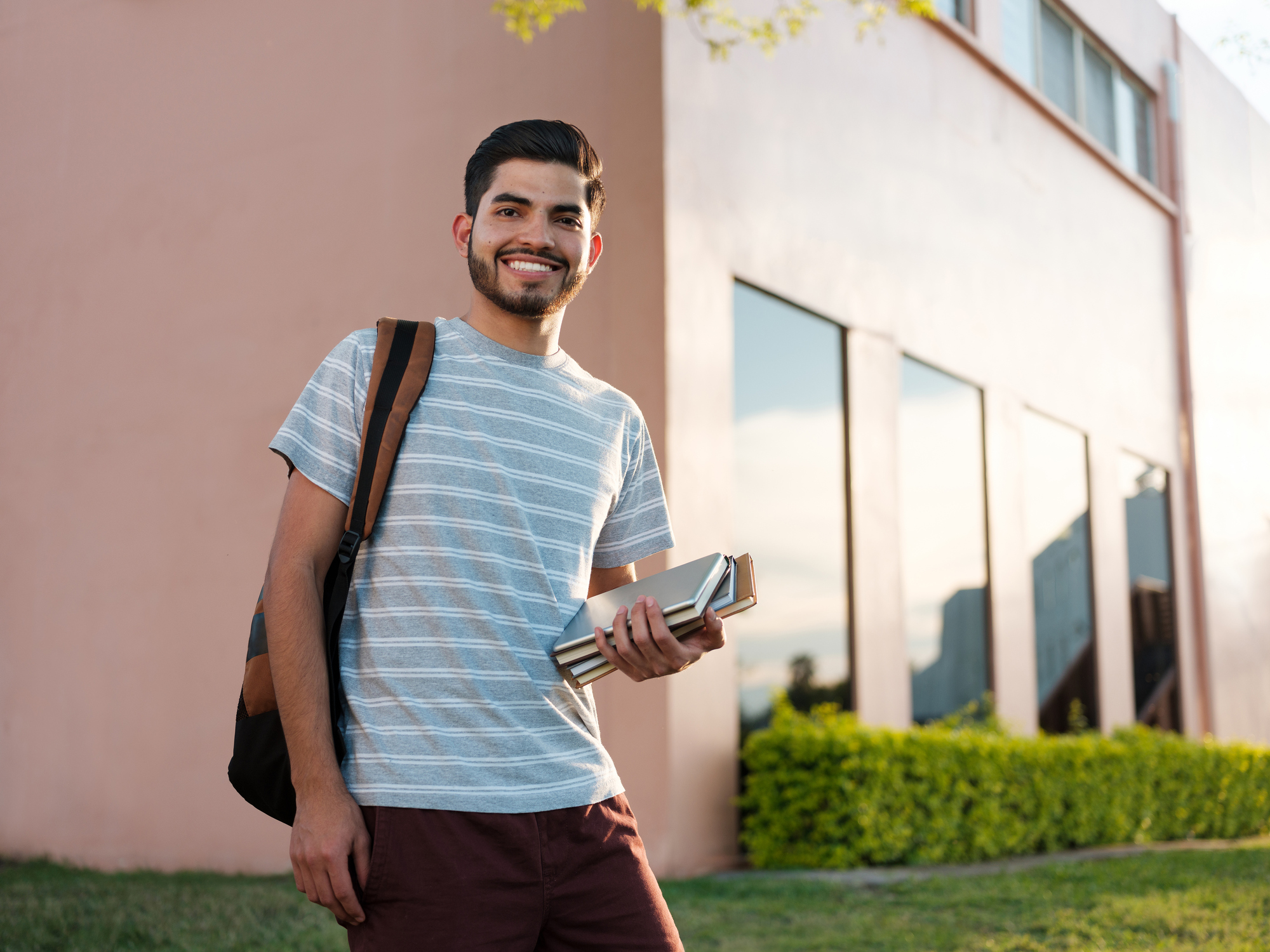 Male student standing outside school.