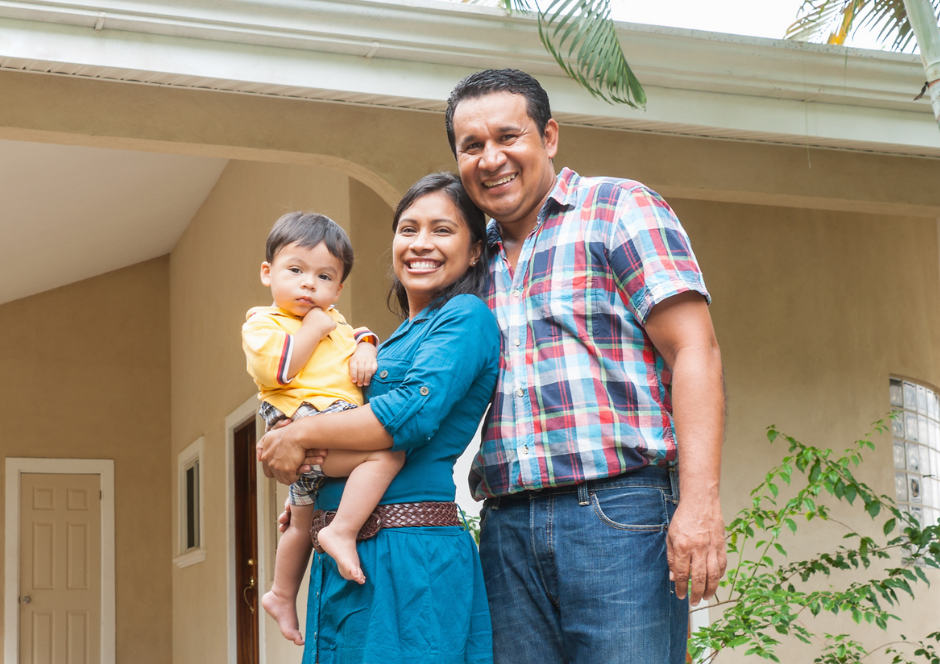 Father, daughter, and grandchild smiling.