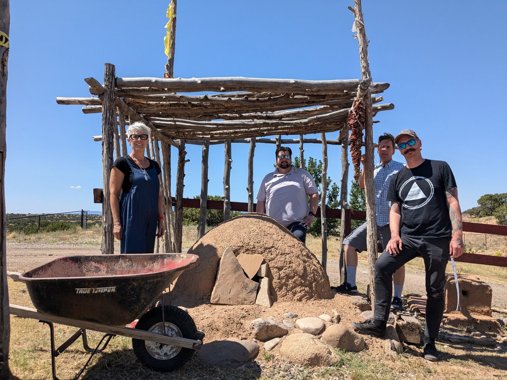 Cornerstones Community Partnerships team standing next to a building project
