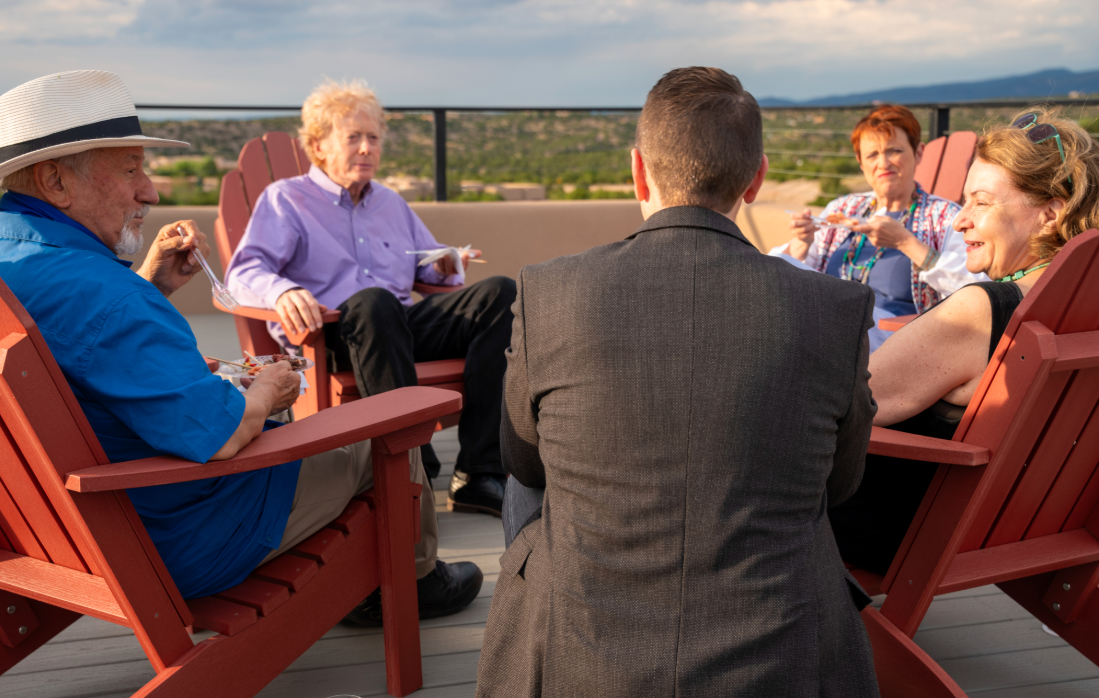 Small party of Foundation stakeholders sitting in circle outdoors