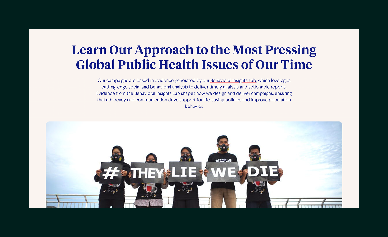 Five people wearing gas masks hold signs that together read '# THEY LIE WE DIE' against a sky background.