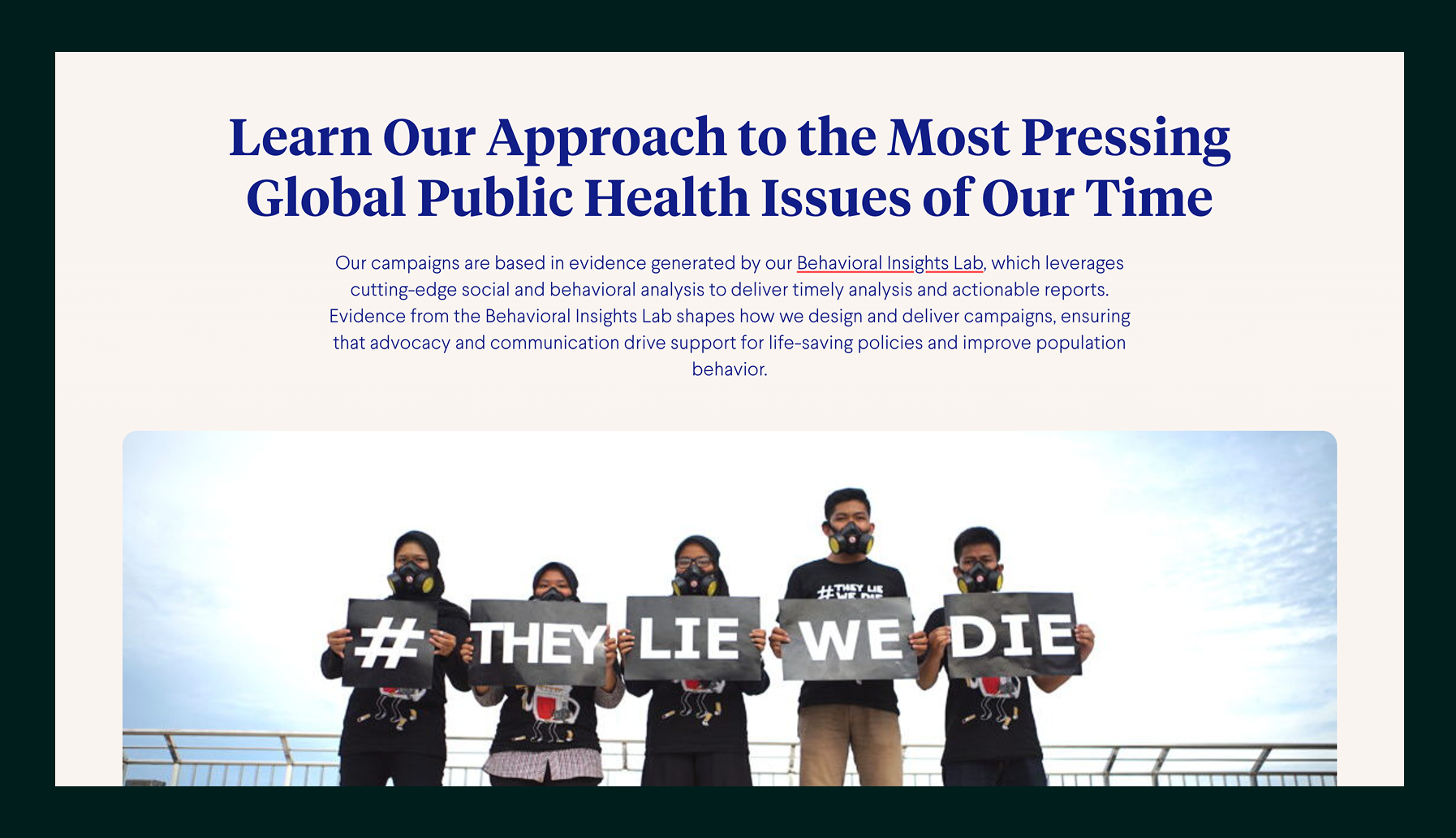 Five people wearing black shirts and protective masks hold signs spelling out '# THEY LIE WE DIE' against a cloudy sky background.