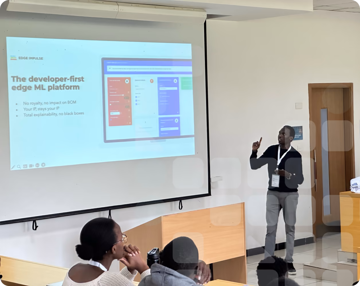 Student presenting an Edge Impulse demo in a classroom, with others watching attentively during a workshop or seminar.