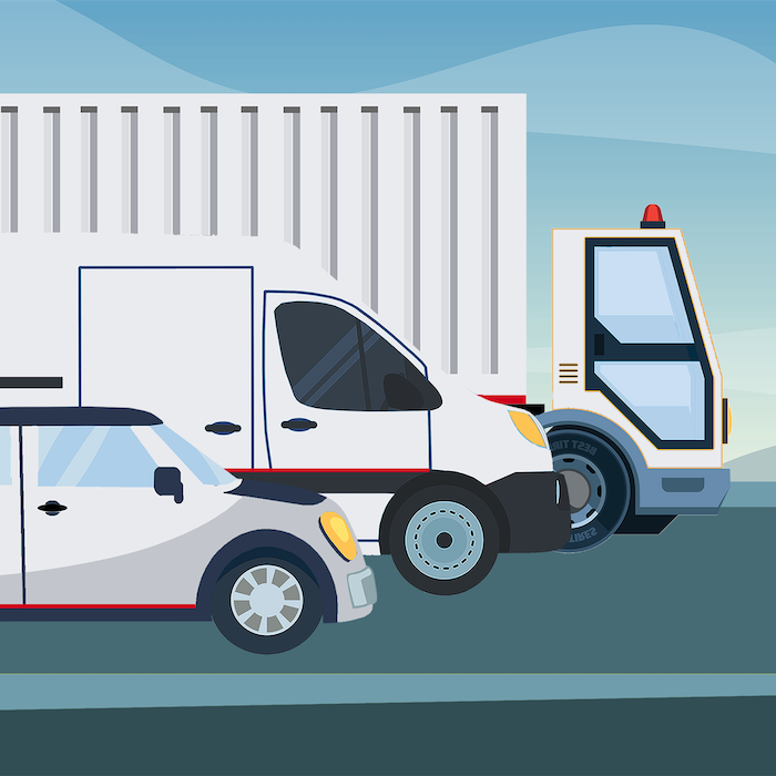 Three commercial vehicles in a line.