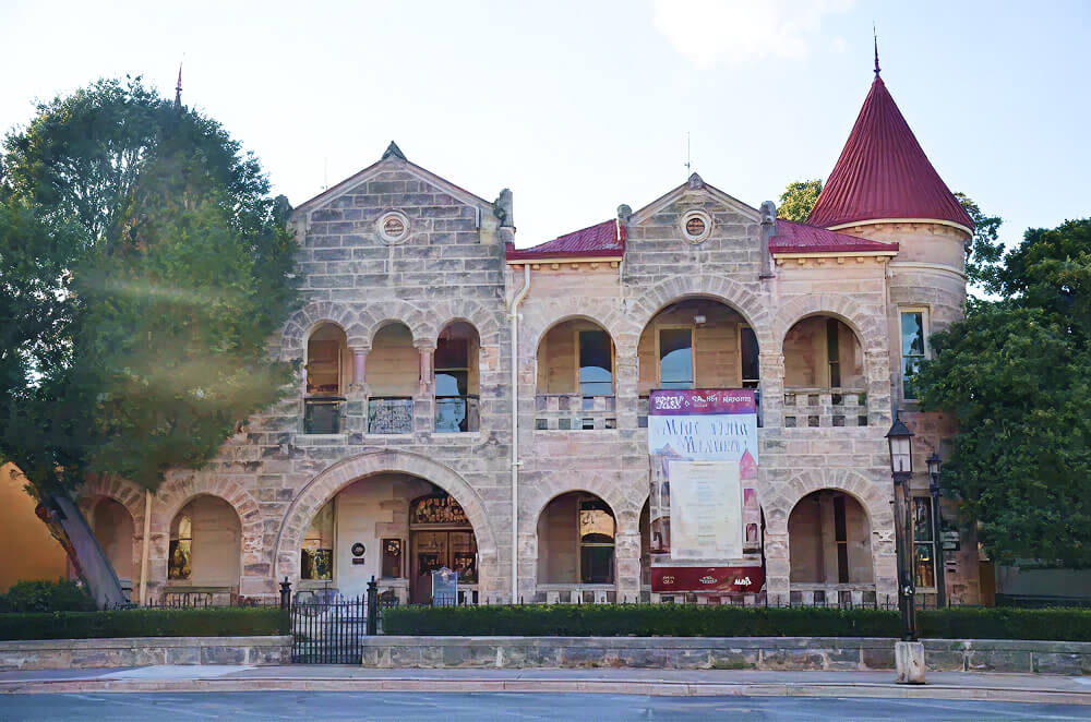 Historic San Antonio building with arches and turret.