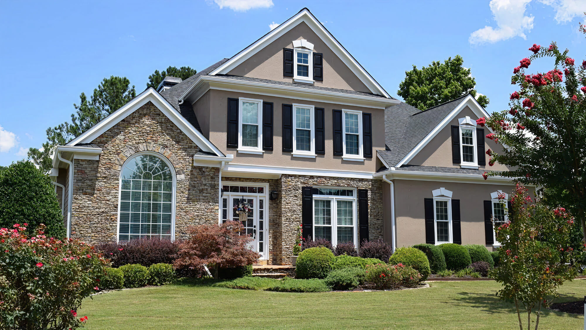Large suburban home with well-maintained lawn.