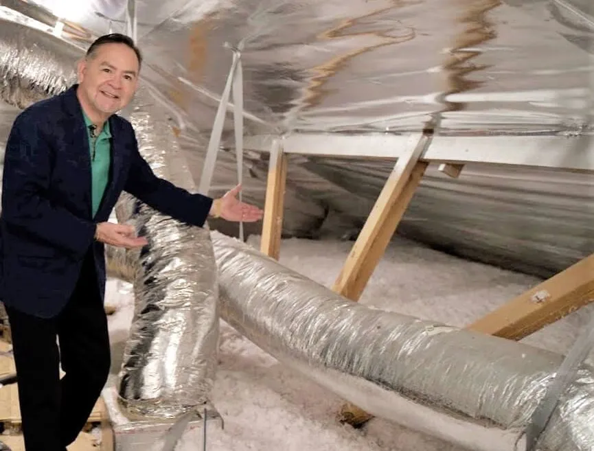 Man showing attic radiant barrier insulation.