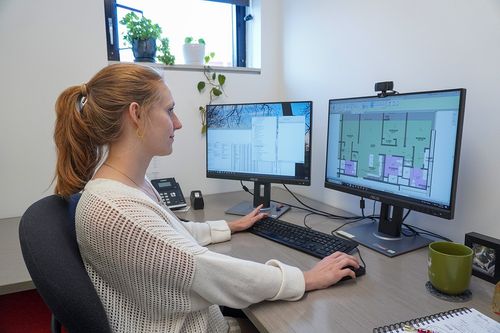 A St. Louis Design Alliance member working at her desk.