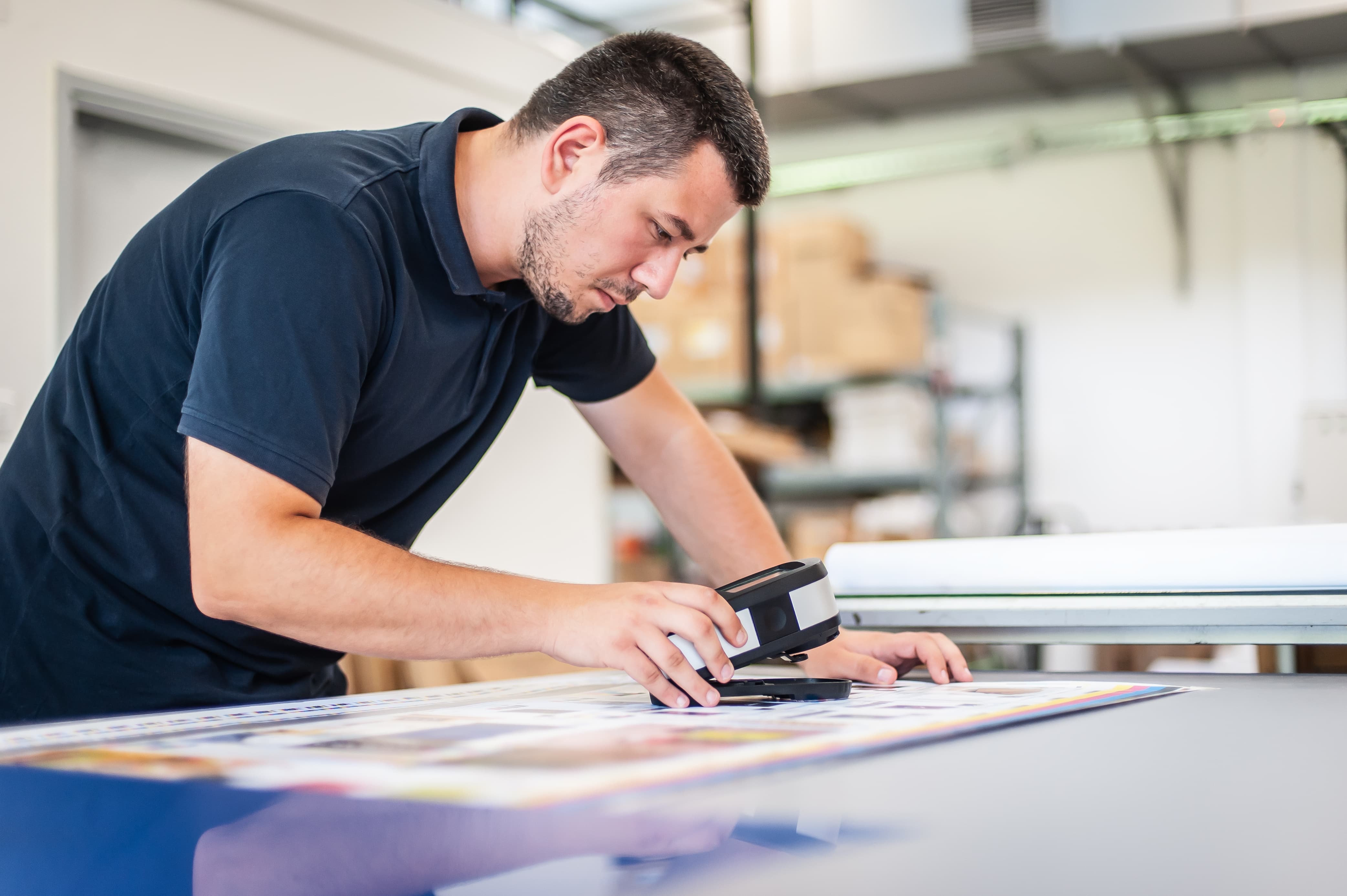 A worker inspecting the printed proof.