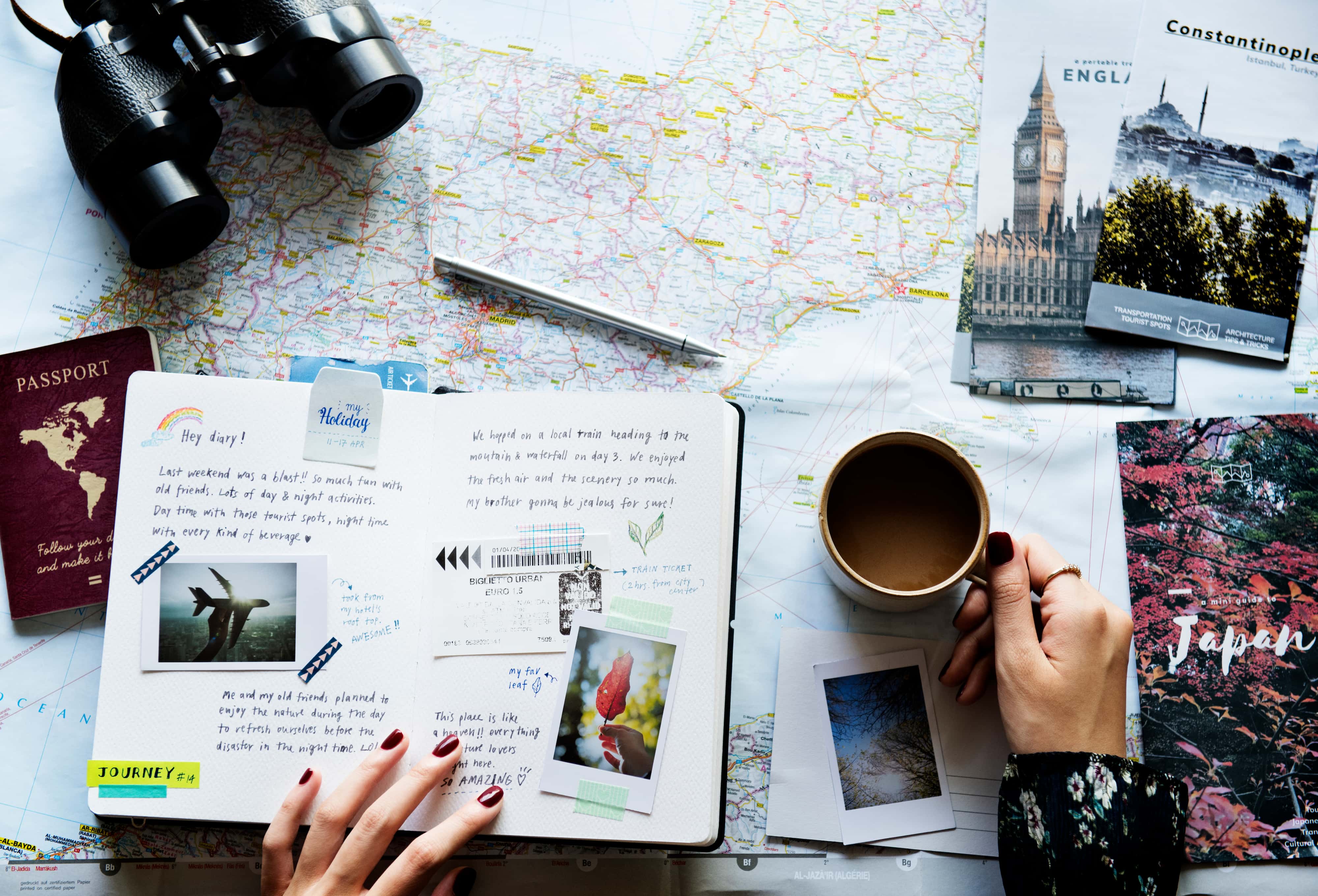 A spread of travel memorabilia, such as brochures, a journal, and a map.